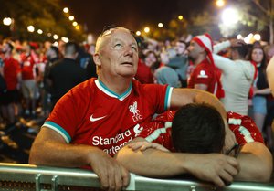 Liverpool supporters react disappointed after the Champions League final soccer match between Liverpool and Real Madrid from a fan park in Paris, France, Saturday, May 28, 2022.