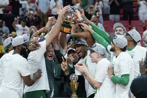 The Boston Celtics players raise the Eastern Conference trophy after defeating the Miami Heat in Game 7 of the NBA basketball Eastern Conference finals playoff series, Sunday, May 29, 2022, in Miami