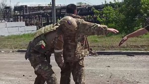 File - In Mariupol, a Russian soldier searches a Ukrainian servicemen at the Azovstal steel plant. The siege of Mariupol was a military action in Ukraine during the 2022 Russian invasion of Ukraine.