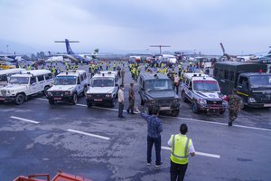 Nepalese army officials load the dead bodies of plane crash victims into ambulances at an airport in Kathmandu, Nepal, Monday, May 30, 2022.