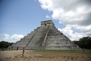 FILE - In this Aug. 3, 2018 file photo, tourists walk at the Mayan ruins of Chichen Itza in Mexico's Yucatan Peninsula.