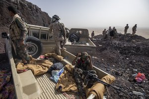 Yemeni fighters backed by the Saudi-led coalition during clashes with Houthi rebels on the Kassara front line near Marib, Yemen, Sunday, June 20, 2021