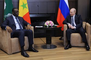 Russian President Vladimir Putin, right, speaks to Senegalese President and the chairman of the African Union Macky Sall during their meeting in the Bocharov Ruchei residence in the Black Sea resort of Sochi, Russia, Friday, June 3, 2022.