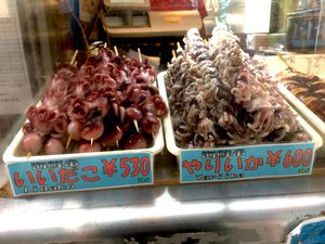 Skewered baby octopuses and squids at a market in Tokyo, Japan. Taken on July 2018.