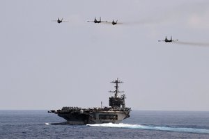 SOUTH CHINA SEA (Oct. 15, 2012) F/A-18s and Su-30s fly above USS Enterprise.