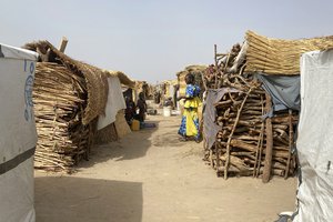 File - People are seen at the Jere  camp of people displaced by Islamist extremists in Maiduguri  Nigeria, Wednesday, May 4, 2022. Iza Ali’s five children are still waiting to eat at 3 p.m. It's not the first day that the family has gone without food since they fled extremist violence.