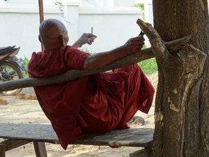 Monk Enjoying a Smoke - Outside Maha Zeya Meditation Hall - Sittwe - Rakhaing (Arakan) State - Myanmar (Burma)