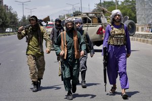 Taliban fighters guard at the site of an explosion in Kabul, Afghanistan, Saturday, June 18, 2022. Several explosions and gunfire ripped through a Sikh temple in Afghanistan's capital.