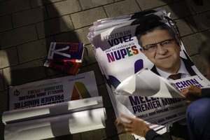 Electoral posters for hard-left leader Jean-Luc Melenchon lay on the pavement ahead of the second round of the legislative elections in Strasbourg, eastern France, Tuesday June 14, 2022.