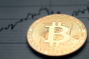 bitcoin on the background of a rising chart