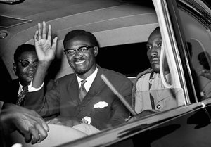 FILE - In this July 24, 1960 file photo, Congo Premier Patrice Lumumba waves as he sits in car for the drive from Idlewild Airport, New York after his arrival from Europe to speak to the United Nations Security Council.