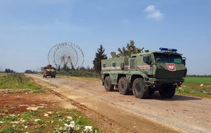 FILE - In this photo provided by the Turkish Defense Ministry, Turkish and Russian troops patrol on the M4 highway, which runs east-west through Idlib province, Syria, March 15, 2020.