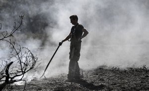 Firefighters works at a national park at the Dutch-German border near Herkenbosch, Netherlands, Wednesday, April 22, 2020. Due to the long dryness the danger of forest fires increases all over Germany.