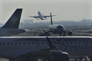 Passenger planes take off from Benito Juárez International Airport in Mexico City, Thursday, May 12, 2022.