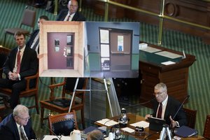 Using photos of doors from Robb Elementary School in Uvalde, Texas, Texas Department of Public Safety Director Steve McCraw testifies at a Texas Senate hearing at the state capitol, Tuesday, June 21, 2022, in Austin, Texas.