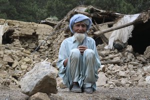 An Afghan man sits near his house that was destroyed in an earthquake in the Spera District of the southwestern part of Khost Province, Afghanistan, Wednesday, June 22, 2022.