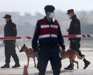 Police officers and soldiers patrol at the entrance of a courthouse during the trial of 475 defendants, including generals and fighter jet pilots, in Sincan, Ankara, Turkey, Thursday, Nov. 26, 2020.