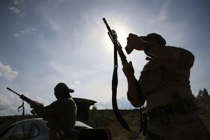 Volunteers from Belarus practice at a shooting range near Warsaw, Poland, on Friday, May 20, 2022.