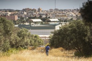 A migrant runs on Spanish soil after crossing the fences separating the Spanish enclave of Melilla from Morocco in Melilla, Spain, Friday, June 24, 2022.