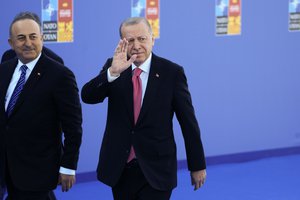 Turkish President Recep Tayyip Erdogan, right, and Turkish Foreign Minister Mevlut Cavusoglu, left, arrive for the NATO summit in Madrid, Spain on Wednesday, June 29, 2022