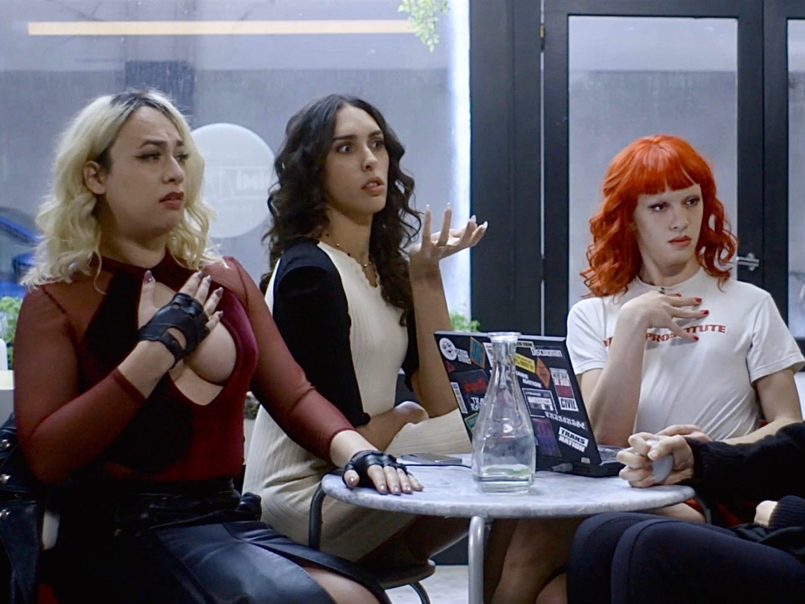 A still from the short film “Terror Sisters” showing four trans women sitting at a cafe table.