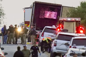 Police and other first responders work the scene where officials say dozens of people have been found dead and multiple others were taken to hospitals with heat-related illnesses after a semitrailer containing suspected migrants was found, Monday, June 27, 2022, in San Antonio.