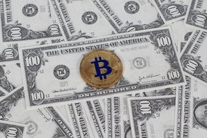 Bitcoin and dollar bills