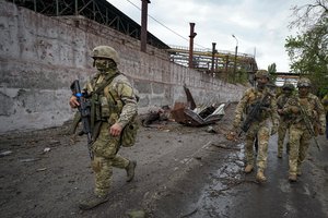 Russian soldiers patrol a destroyed part of the Illich Iron & Steel Works Metallurgical Plant in Mariupol, in territory under the government of the Donetsk People's Republic, eastern Ukraine, Wednesday, May 18, 2022