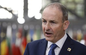 Ireland's Prime Minister Micheal Martin speaks with the media as he arrives for an EU summit in Brussels, Friday, Oct. 16, 2020.