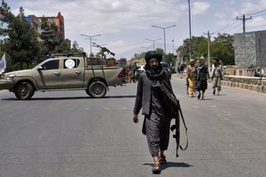 File - Taliban fighters guard at the site of an explosion in Kabul, Afghanistan, Saturday, June 18, 2022. Several explosions and gunfire ripped through a Sikh temple in Afghanistan's capital.