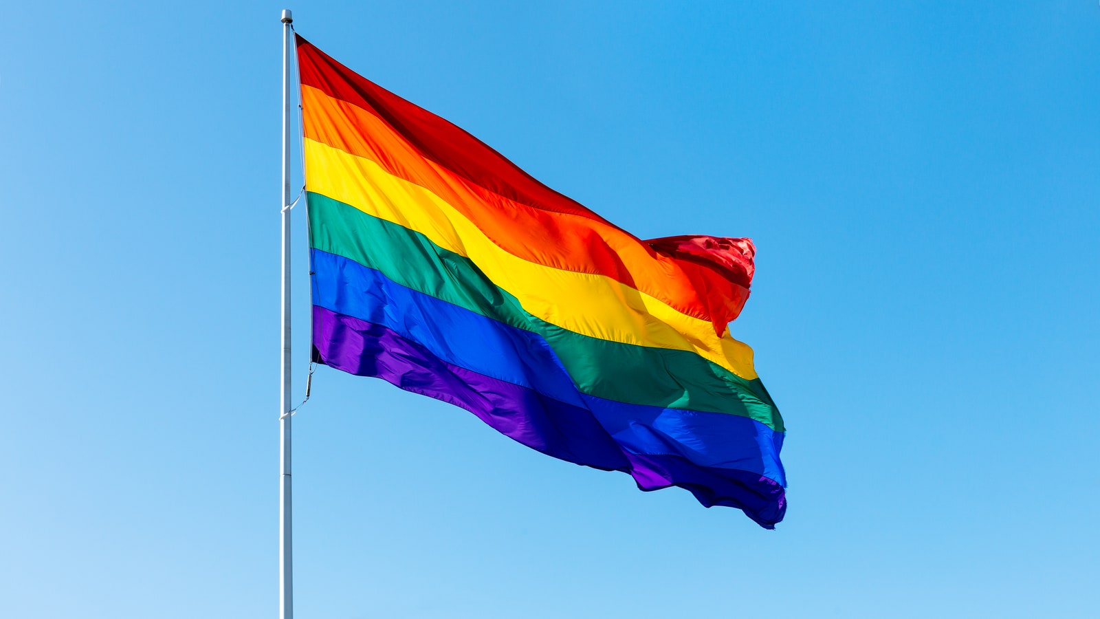 The LGBTQ flag blowing in the wind.