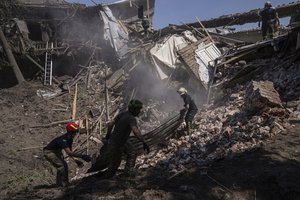 Rescue workers clearing rubble of destroyed house after a Russian attack in a residential neighborhood in downtown Kharkiv, Ukraine, on Saturday, July 9, 2022.