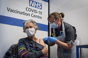 Dr Doreen Brown, 85, receives the first of two Pfizer/BioNTech COVID-19 vaccine jabs administered at Guy's Hospital in London, Tuesday, Dec. 8, 2020.