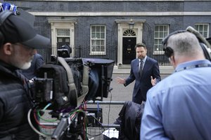 Journalists wait opposite 10 Downing Street in London, Wednesday, July 6, 2022.