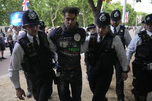 File - A protester is detained by police officers prior to the Platinum Jubilee concert, London, Saturday June 4, 2022, on the third of four days of celebrations to mark the Platinum Jubilee.