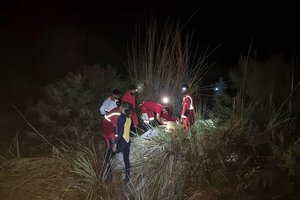 In this photo provided by the Iranian Red Crescent Society on Saturday, July 23, 2022, members of a rescue team search for missing people of Friday's flash floods in Iran's drought-stricken southern Fars province, Iran