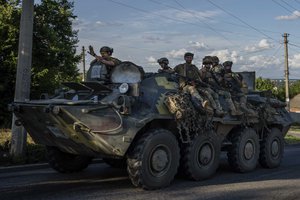 Ukrainian soldiers ride a tank, on a road in Donetsk region, eastern Ukraine, Wednesday, July 20, 2022