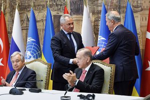 In this handout photo released by Russian Defense Ministry Press Service, Turkish President Recep Tayyip Erdogan, right, and U.N. Secretary General, Antonio Guterres, sit as Russian Defense Minister Sergei Shoigu, top left, and Turkish Defense Minister Hulusi Akar, top right, exchange documents during a signing ceremony at Dolmabahce Palace in Istanbul, Turkey, Friday, July 22, 2022