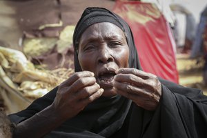 File - Dhahabo Isse, 60, describes how she fled from the drought without food or water causing four of her children to die of hunger, outside her makeshift tent at a camp for the displaced on the outskirts of Mogadishu, Somalia Thursday, June 30, 2022. The war in Ukraine has abruptly drawn millions of dollars away from longer-running humanitarian crises and Somalia is perhaps the most vulnerable as thousands die of hunger amid the driest drought in decades.