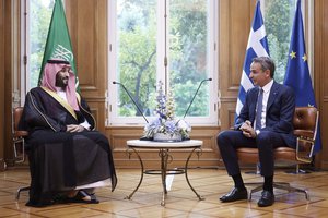 This photo provided by the Greek Prime Minister's Office shows Greece's Prime Minister Kyriakos Mitsotakis, right, speaks with Saudi Crown Prince Mohammed bin Salman during their meeting, in Athens, on Tuesday, July 26, 2022