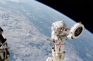 June 9, 2002, Astronaut Franklin R. Chang-Diaz works with a grapple fixture during extravehicular activity (EVA) to perform work on the International Space Station (ISS).