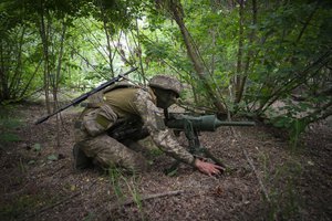 File - A soldier of Ukraine's special operations unit lays a Germany-donated DM22 directional anti-tank mine on a forest road on the Russian troops' potential way in the Donetsk region, Ukraine, on June 14, 2022. Even as Russian troops slowly press their offensive across Ukraine's east, trying to achieve the Kremlin's goal of securing full control over the country's industrial heartland, Ukrainian forces are scaling up attacks to reclaim territory in the Russian-occupied south.