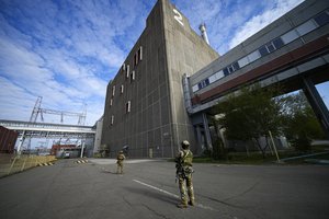 File - Russian servicemen guard an area of the Zaporizhzhia Nuclear Power Station, the largest nuclear power plant in Europe and among the 10 largest in the world in Enerhodar, Zaporizhzhia region, in territory under Russian military control, southeastern Ukraine, Sunday, May 1, 2022.