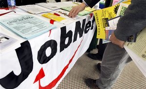 A man collects literature at the Access Opportunity Career Fair in Boston Thursday, April 2, 2009 which was held to assist job seekers with information and resources to improve their chances of finding a job in today's tough market. The nation's unemployment rate jumped to 8.5 percent in March, the highest since late 1983, as a wide range of employers eliminated a net total of 663,000 jobs