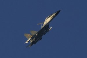 A Chinese J-11 military fighter jet flies above the Taiwan Strait near Pingtan, the closest land of mainland China to the island of Taiwan, in Pingtan in southeastern China's Fujian Province, Friday, Aug. 5, 2022