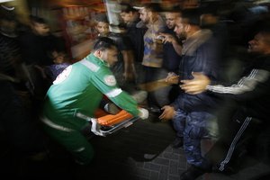 Palestinian medics aid a wounded man in the al-Shifa hospital in Gaza City following an Israeli air strike on November 15, 2012. An Israeli airstrike has killed Hamas's top commander, Ahmed Al-Jaabari, in Gaza. According to a military spokeswoman this is only "the beginning" of an operation to target militant groups in the strip.Photo by Ahmed Deeb / WN