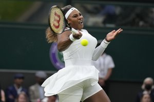 Serena Williams of the US plays a return to Aliaksandra Sasnovich of Belarus for the women's singles first round match on day two of the Wimbledon Tennis Championships in London, Tuesday June 29, 2021