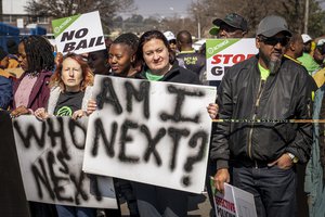 Women protest outside the Krugersdorp, South Africa, Magistrates Court Monday, Aug. 1, 2022