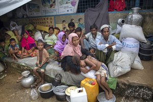 File - Rohingya Muslims, who crossed over from Myanmar into Bangladesh, rest inside a school compound at Kutupalong refugee camp, Bangladesh, Monday, Oct. 23, 2017.