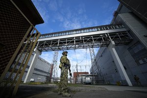 A Russian serviceman guards an area of the Zaporizhzhia Nuclear Power Station in territory under Russian military control, southeastern Ukraine, May 1, 2022.